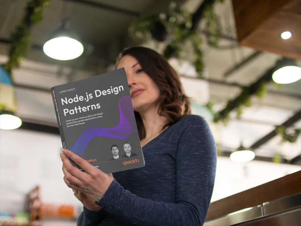 Lifestyle shot of a woman in a cafe holding the “Node.js Design Patterns – Fourth Edition” book; greenery and warm lights in the background, cover fully visible.